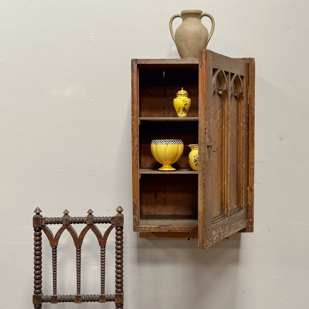 A Regency Pine Grain Painted Gothic Cupboard